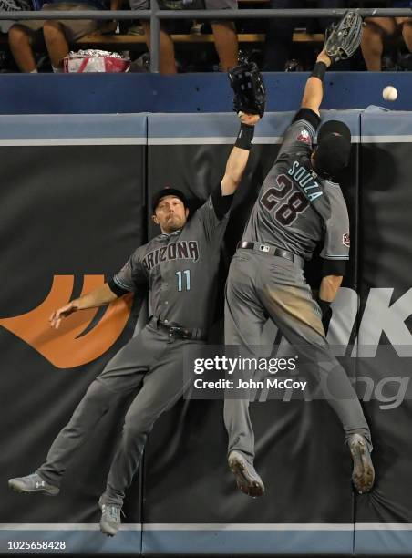 Pollock of the Arizona Diamondbacks and Steven Souza Jr. #28 can not get this home run ball hit by Enrique Hernandez of the Los Angeles Dodgers in...