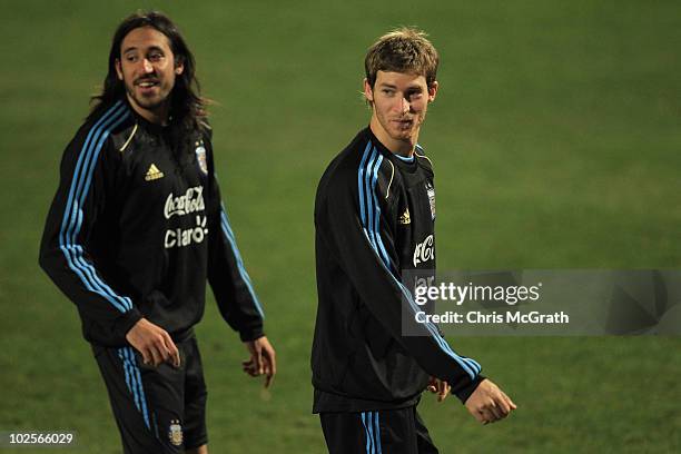 Jonas Gutierrez and team mate Mario Bolatti of Argentina's national football team prepare to run laps during a team training session on July 1, 2010...