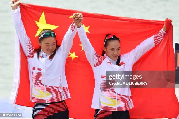 China's gold medallists Li Yue and Zhou Yu pose on the podium during the awards ceremony for the women's kayak double sprint 500m competition at the...