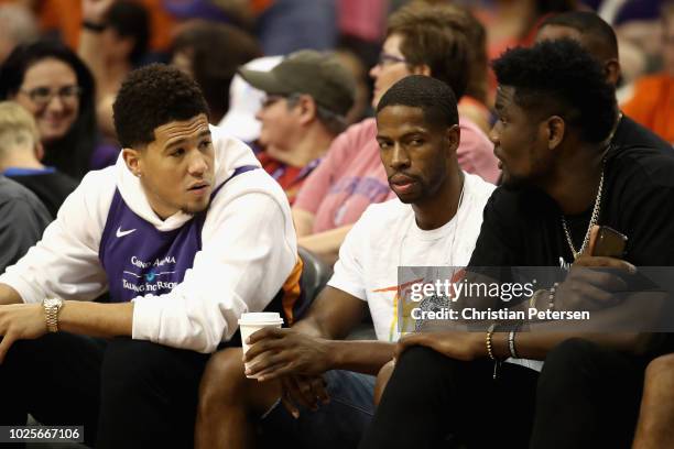 Devin Booker and Deandre Ayton of the Phoenix Suns talk during game three of the WNBA Western Conference Finals between the Seattle Storm and the...