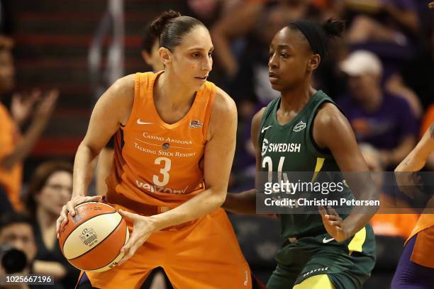 Diana Taurasi of the Phoenix Mercury handles the ball against Jewell Loyd of the Seattle Storm during game three of the WNBA Western Conference...