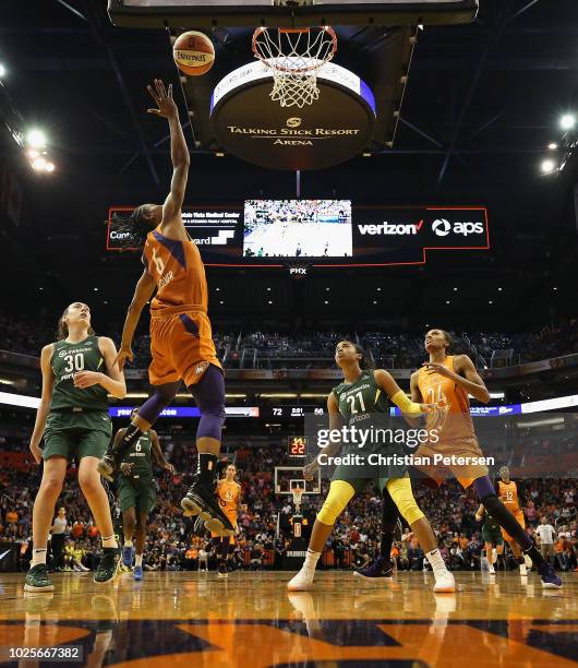 Yvonne Turner of the Phoenix Mercury lays up a shot past Breanna Stewart and Jordin Canada of the Seattle Storm during game three of the WNBA Western...