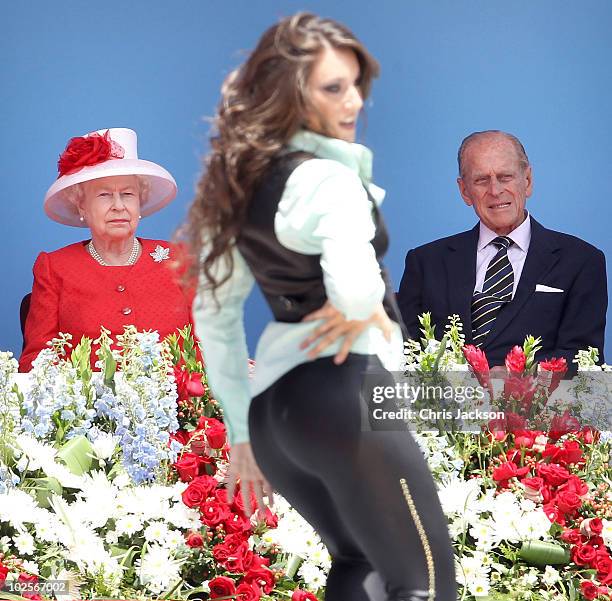 Queen Elizabeth II and Prince Philip, Duke of Edinburgh watch a dancer perform during Canada Day celebrations on Parliament Hill on July 1, 2010 in...