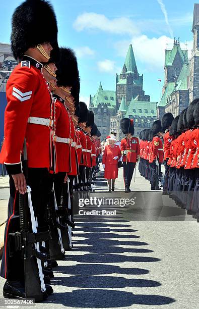 Queen Elizabeth II inspects a Guard of Honour outside the Canadian Parliament, after arriving to attend the Canada Day celebrations on July 1, 2010...