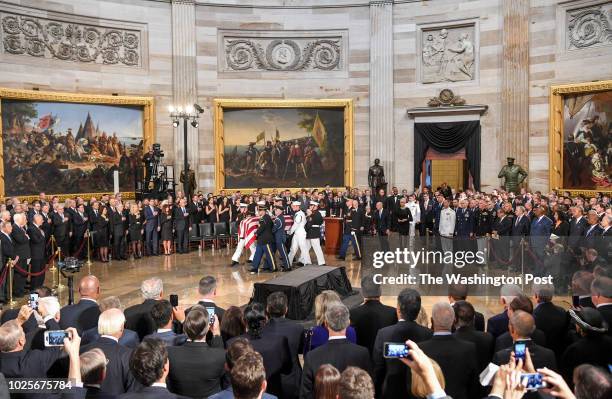 The body of late-Sen. John S. McCain arrives to lie in state during a ceremony to honor the six-term senator from Arizona in the Capitol Rotunda on...