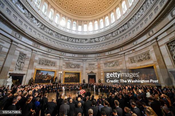 The body of late-Sen. John S. McCain lies in state during a ceremony to honor the six-term senator from Arizona in the Capitol Rotunda on Friday. He...