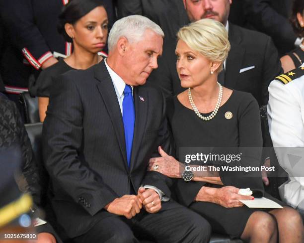 Vice President Mike Pence talks with Cindy McCain after he made remarks as the body of late-Sen. John S. McCain lies in state during a ceremony to...