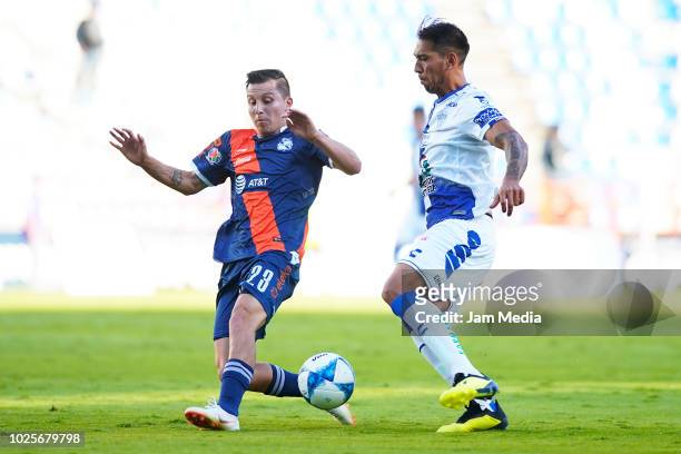 Jose Torres of Puebla fights for the ball with Leonardo Ulloa of Pachuca during the 7th round match between Pachuca and Puebla as part of the Torneo...