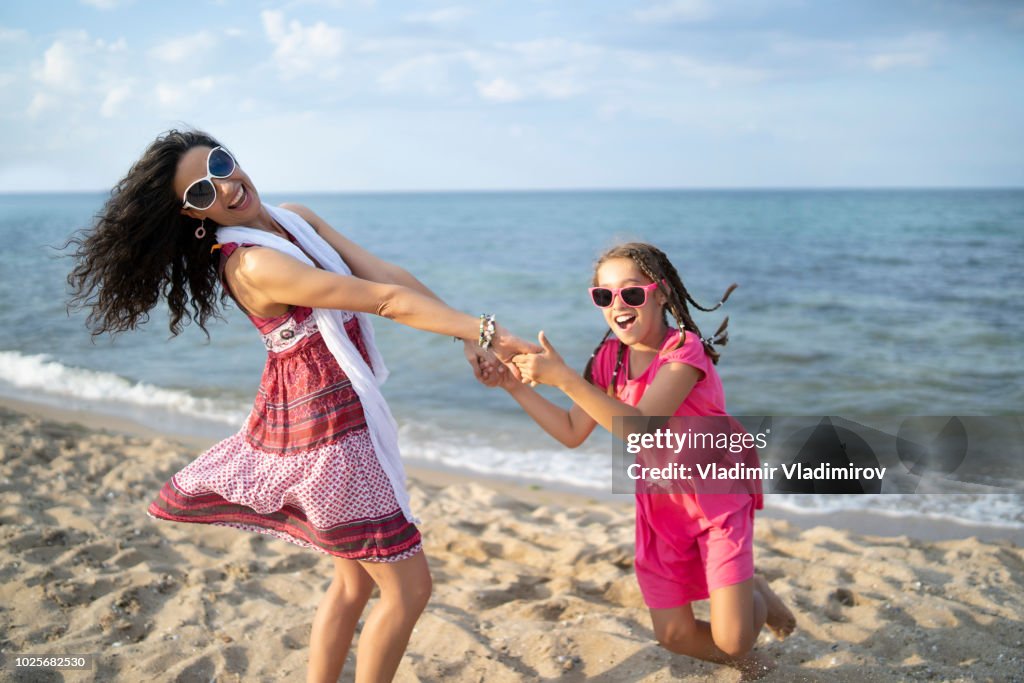 Mother and daugther playing on beach