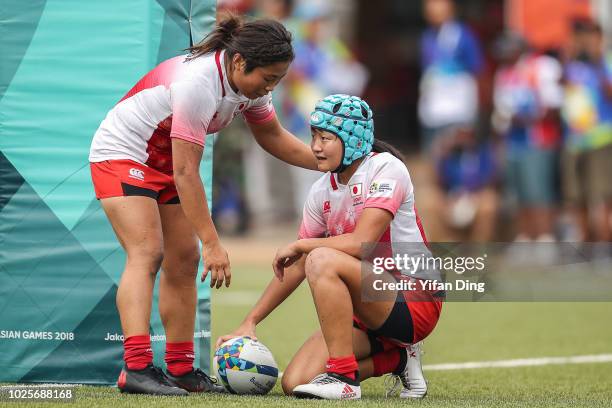 Kuwai Ano of Japan and Tateyama Yukari of Japan reacts during Rugby Sevens Women's Semi Final between Japan and Kazakhstan at GBK Rugby Field on day...