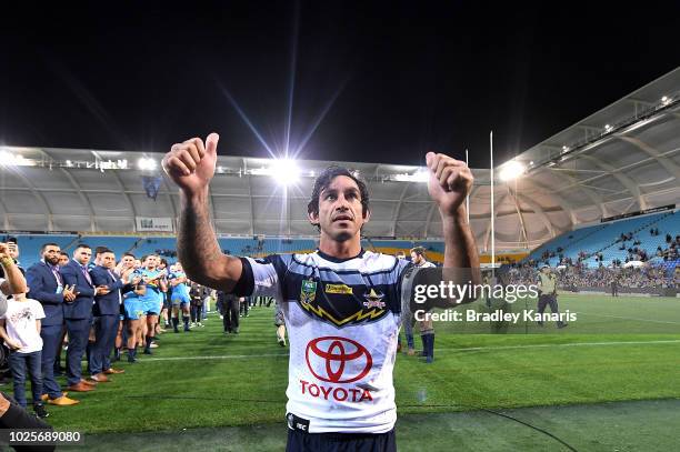 Johnathan Thurston of the Cowboys farewells fans as he celebrates his last NRL match after the round 25 NRL match between the Gold Coast Titans and...