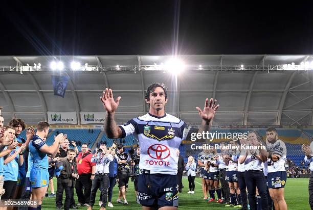 Johnathan Thurston of the Cowboys farewells fans as he celebrates his last NRL match after the round 25 NRL match between the Gold Coast Titans and...