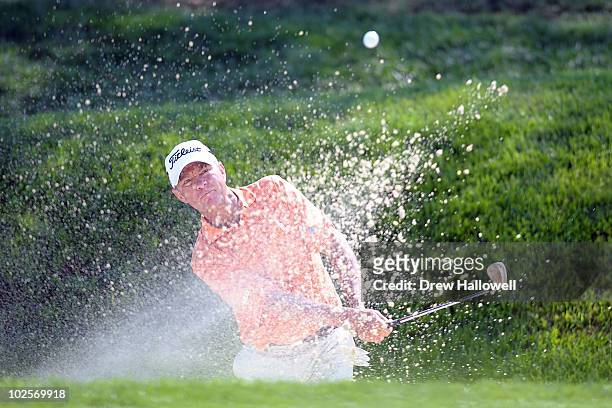 Davis Love III hits a shot out of the bunker on the 13th hole during the first round of the AT&T National at Aronimink Golf Club on July 1, 2010 in...