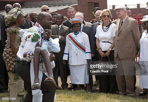 Queen Paola of Belgium and King Albert II of Belgium watch as a performers enact a scene during a visit to the King Boudewijn Hospital on July 1,...