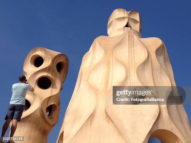 tourist photographing sculptures - la pedrera stock pictures, royalty-free photos & images