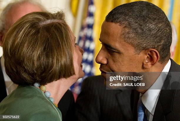 President Barack Obama greets Speaker of the House Nancy Pelosi before signing the Iran Sanctions Bill in the East Room of the White House in...