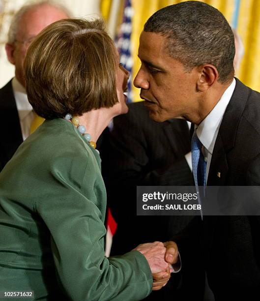 President Barack Obama greets Speaker of the House Nancy Pelosi before signing the Iran Sanctions Bill in the East Room of the White House in...