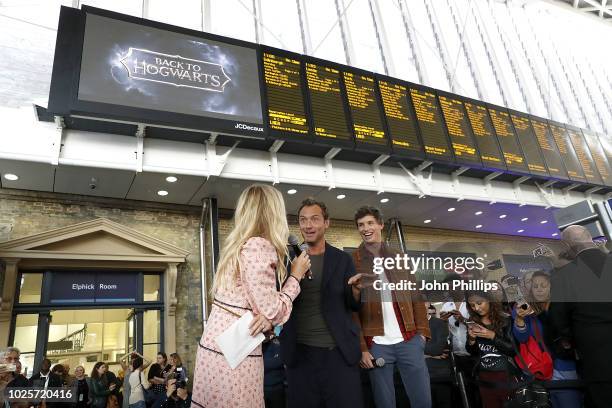Eddie Redmayne and Jude Law , stars of Fantastic Beasts: The Crimes Of Grindelwald, surprise fans at platform 9 3/4 during 'Back to Hogwarts' day...