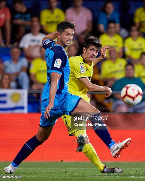Gerard of Villarreal CF kicks the ball next to Juan Pedro Ramirez Lopez Juanpe of Girona FC during the La Liga match between Villarreal CF and Girona...