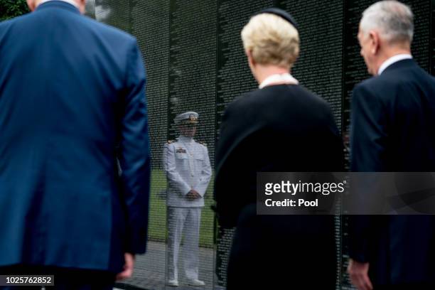 Navy Lt. Jack McCain, the son of, Sen. John McCain, R-Ariz., is reflected in the wall of the Vietnam Memorial as Jack's mother, Cindy McCain,...
