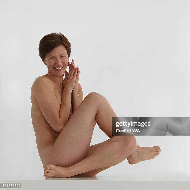 beauty shot of naked, mature woman - natural portrait studio shot white background stock-fotos und bilder