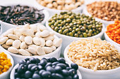 Various raw legumes and rice in bowls