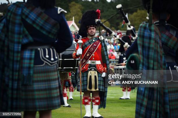 Competitors take part in the Massed Pipe Band parade at the annual Braemar Gathering in Braemar, central Scotland, on September 1, 2018. - The...
