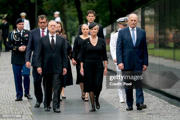 Cindy McCain, wife of, Sen. John McCain, R-Ariz., accompanied by President Donald Trump's Chief of Staff John Kelly, right, Defense Secretary Jim...