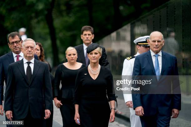 Cindy McCain, wife of, Sen. John McCain, R-Ariz., center, accompanied by President Donald Trump's Chief of Staff John Kelly, right, Defense Secretary...