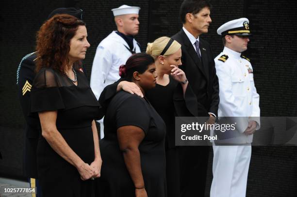 Bridget McCain, and Meghan McCain hug while U.S. Secretary of Defense James Mattis, General John Kelly, White House Chief of Staff and Cindy McCain,...
