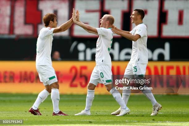 Yuya Osako, Davy Klaassen and Maximilian Eggestein of Werder Bremen celebrates after Yuya Osako of Werder Bremen scored their team's first goal...