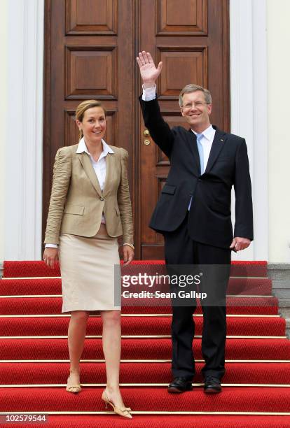 New German President Christian Wulff and his wife, First Lady Bettina Wulff, pose at the entrance to Schloss Bellevue presidential palace after Wulff...
