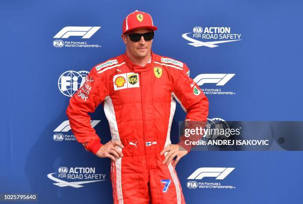 Ferrari's Finnish driver Kimi Raikkonen celebrates winning the pole position after the qualifying session at the Autodromo Nazionale circuit in Monza...