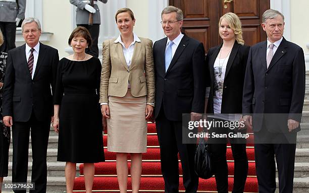New German President Christian Wulff and his wife, First Lady Bettina Wulff , pose with outgoing interim President Jens Boehrnsen, former First Lady...