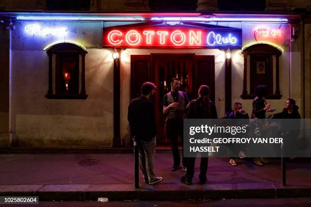 Peoplestand outside the Cotton Club bar, formerly an escort-girl bar, in the Pigalle area of Paris, on August 31, 2018. - In the southern section of...