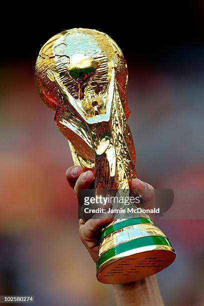 Replica of the World Cup trophy is held aloft prior to the 2010 FIFA World Cup South Africa Quarter Final match between Netherlands and Brazil at...
