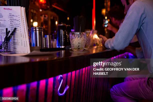 Client has a drink in the Pile ou Face, formerly an escort-girl bar, in the Pigalle area of Paris, on July 5, 2018. - In the southern section of...