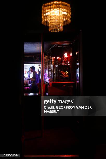 Bartender works in the Pile ou Face, formerly an escort-girl bar, in the Pigalle area of Paris, on July 5, 2018. - In the southern section of Paris'...