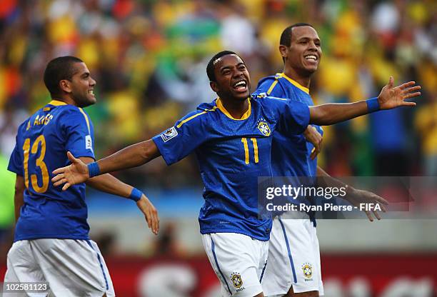 Robinho of Brazil celebrates scoring the opening goal with teammates Dani Alves and Luis Fabiano during the 2010 FIFA World Cup South Africa Quarter...