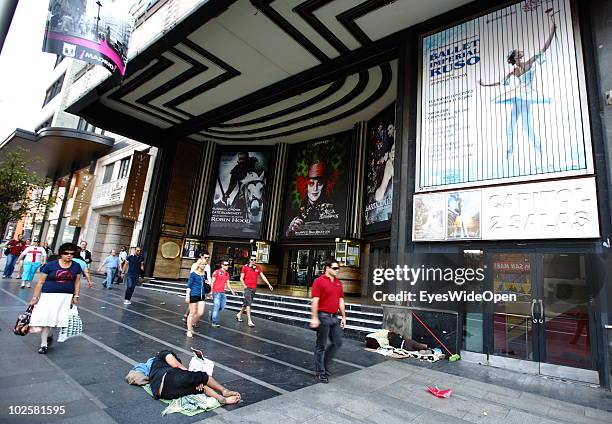 Homeless people are seen sleeping and begging on the pedestrian path at the famous boulevard Gran Via in Madrid on May 24, 2010 in Madrid, Spain....