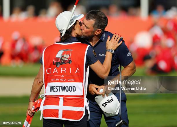 Lee Westwood of England kisses his girlfriend and caddie, Helen Storey on the 18th green after completing his third round of the Made in Denmark...