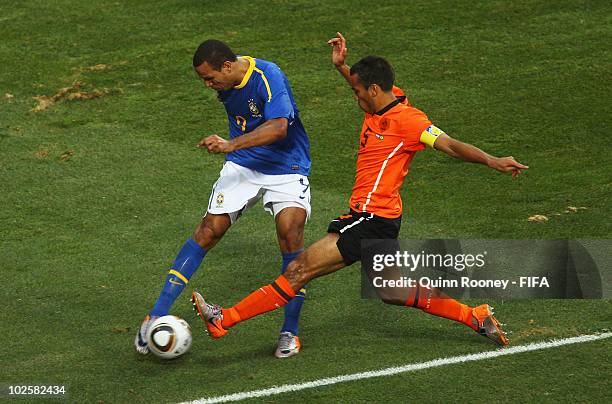 Luis Fabiano of Brazil in action against Giovanni Van Bronckhorst of the Netherlands during the 2010 FIFA World Cup South Africa Quarter Final match...