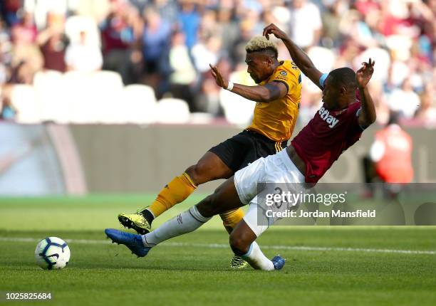 Adama Traore of Wolverhampton Wanderers scores his team's first goal during the Premier League match between West Ham United and Wolverhampton...