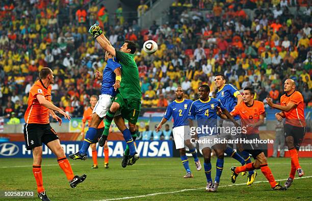 Felipe Melo and Julio Cesar of Brazil jump to defend a cross from Wesley Sneijder of the Netherlands which results in an own goal by Melo during the...
