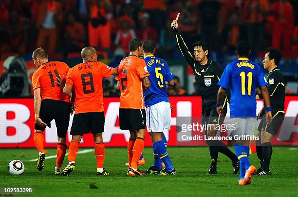 Referee Yuichi Nishimura issues a red card to Felipe Melo of Brazil after he stamps on Arjen Robben of the Netherlands during the 2010 FIFA World Cup...