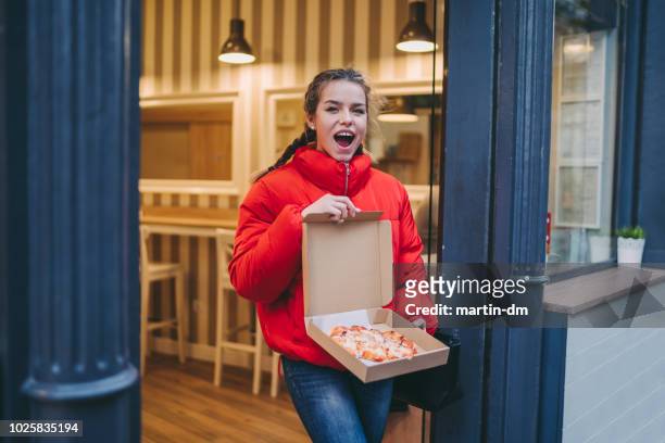 happy woman with pizza - leaving restaurant stock pictures, royalty-free photos & images