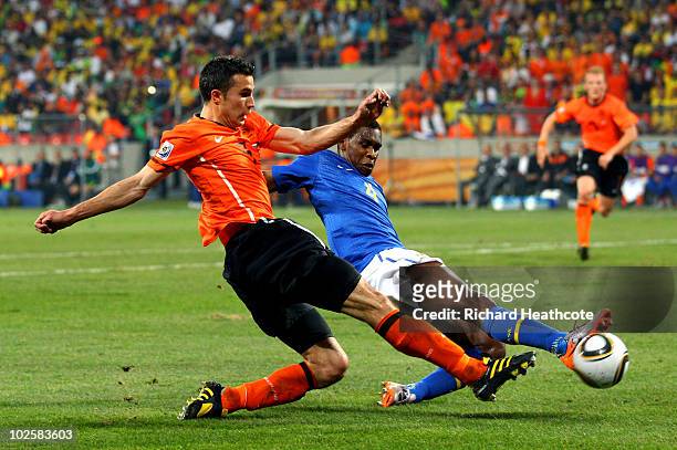 Juan of Brazil tackles Robin Van Persie of the Netherlands during the 2010 FIFA World Cup South Africa Quarter Final match between Netherlands and...