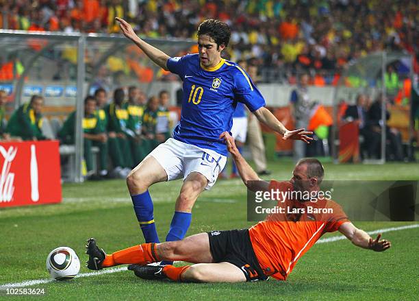 Andre Ooijer of the Netherlands tackles Kaka of Brazil during the 2010 FIFA World Cup South Africa Quarter Final match between Netherlands and Brazil...