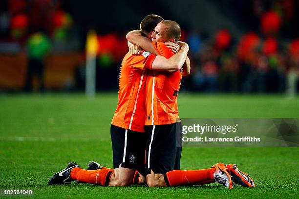 Andre Ooijer of the Netherlands celebrates with team mate John Heitinga after victory and progress to the semi-finals during the 2010 FIFA World Cup...