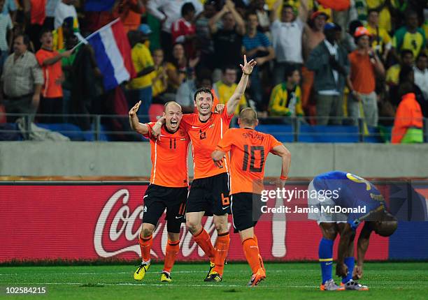 Wesley Sneijder celebrates victory at the final whistle with Arjen Robben and Mark Van Bommel of the Netherlands during the 2010 FIFA World Cup South...